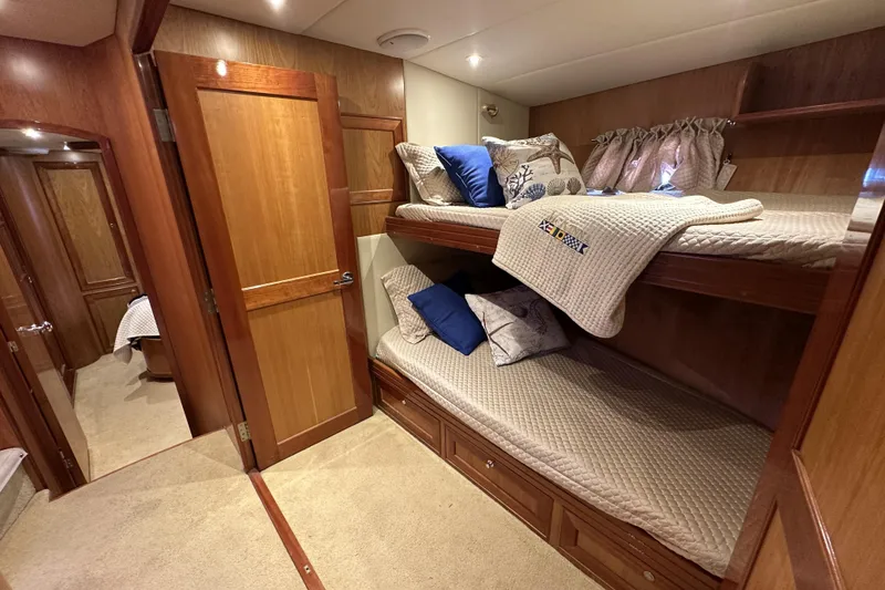 Slide: The Image of Luxurious 2004 McKinna 57 PHMY yacht cabin with cozy bunk beds and elegant wood finish. - 82