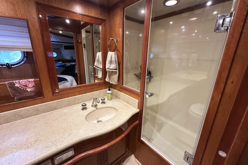 Slide: The Image of Luxurious bathroom in 2004 McKinna 57 PHMY yacht with wood accents and glass shower. - 87