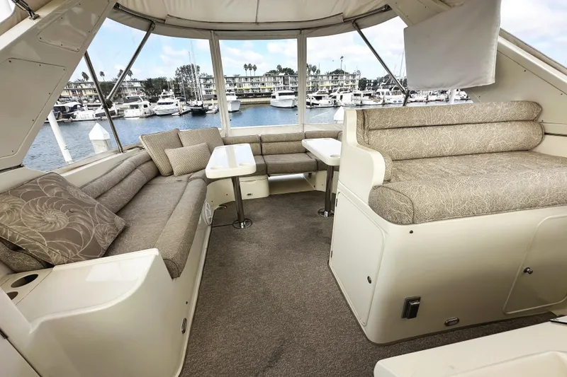 Slide: The Image of Luxurious interior of 2004 McKinna 57 PHMY yacht with plush seating and marina view. - 90