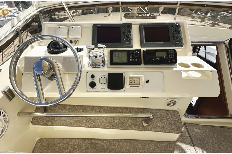 Slide: The Image of 2004 McKinna 57 PHMY yacht helm with dual navigation screens and control panel. - 97