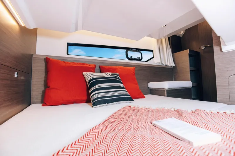 Slide: The Image of Interior cabin of 2026 Jeanneau NC895 Sport with cozy bedding and vibrant pillows. - 19
