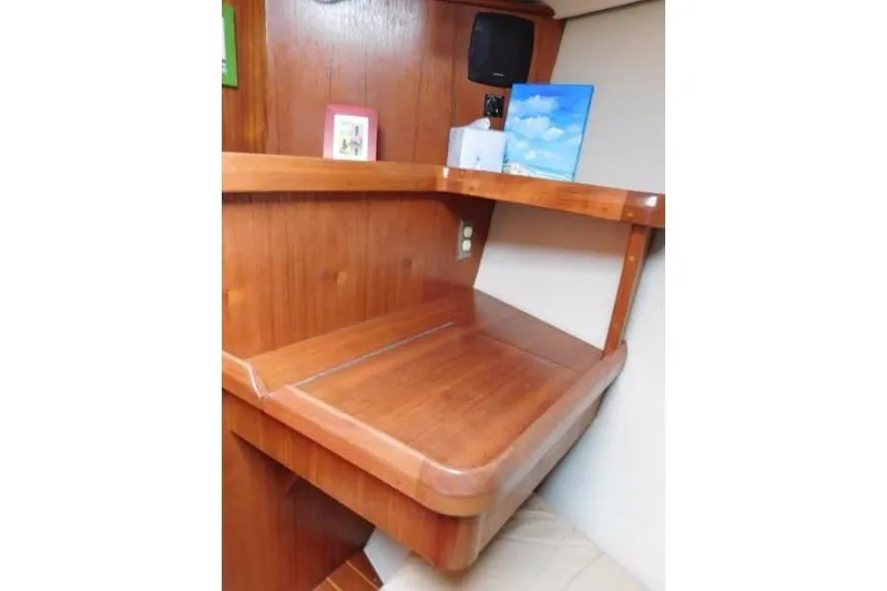 Slide: The Image of 1994 Hunter Passage 42 yacht interior with wooden desk and shelf. - 13
