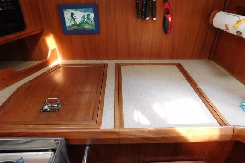 Slide: The Image of 1994 Hunter Passage 42 yacht kitchen with wooden countertops and knife rack. - 14
