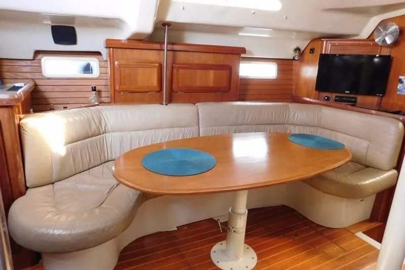 Slide: The Image of Interior of 1994 Hunter Passage 42 yacht with cozy seating and wooden table. - 17