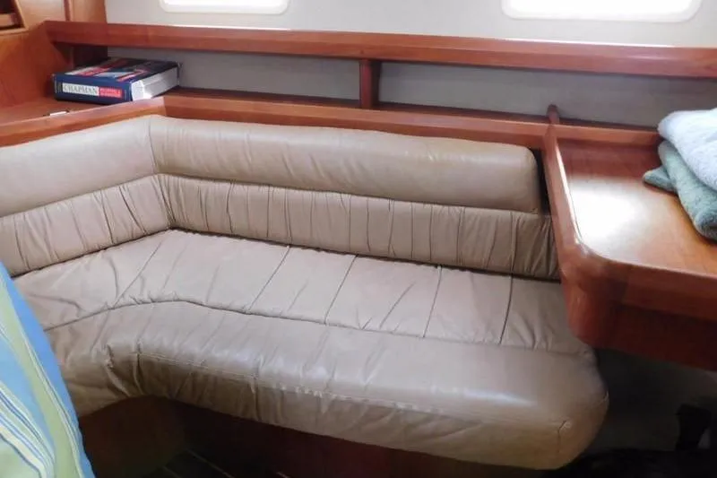Slide: The Image of 1994 Hunter Passage 42 yacht interior with beige leather seating and wooden accents. - 19
