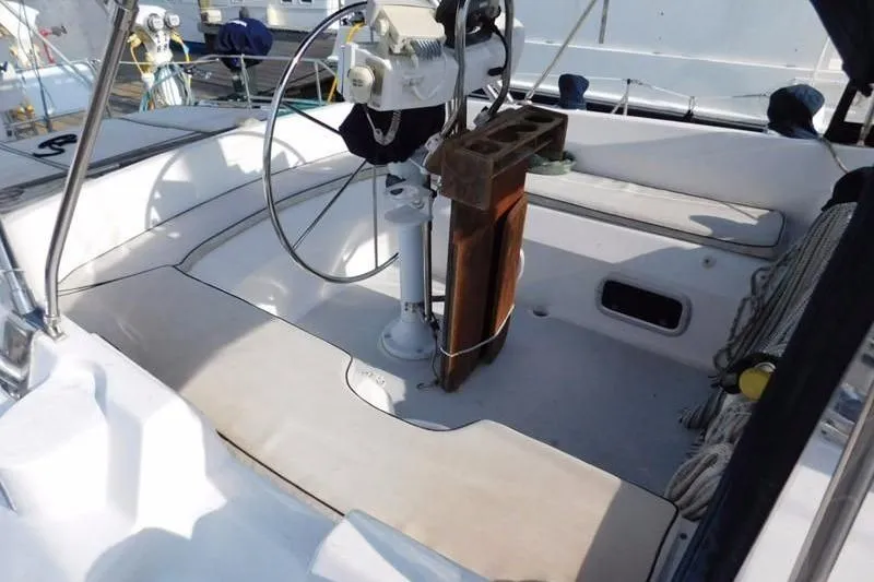 Slide: The Image of Cockpit of 1994 Hunter Passage 42 sailboat with steering wheel and seating area. - 2
