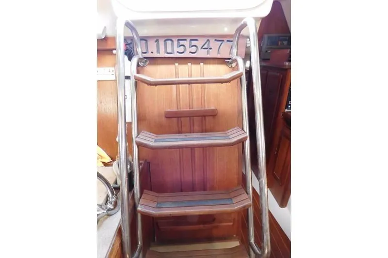 Slide: The Image of 1994 Hunter Passage 42 yacht interior with wooden steps and metal railings. - 20