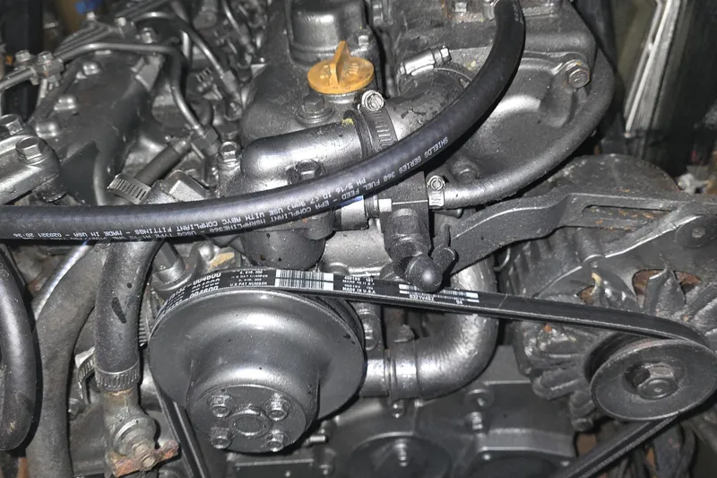 Slide: The Image of Engine of a 1994 Hunter Passage 42 sailboat, showing belts and hoses. - 7