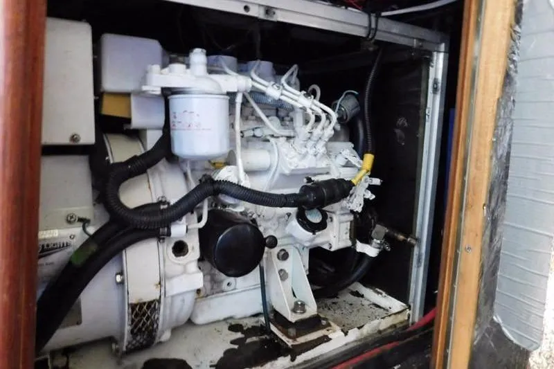 Slide: The Image of Engine compartment of a 1994 Hunter Passage 42 sailboat, showcasing mechanical components. - 8