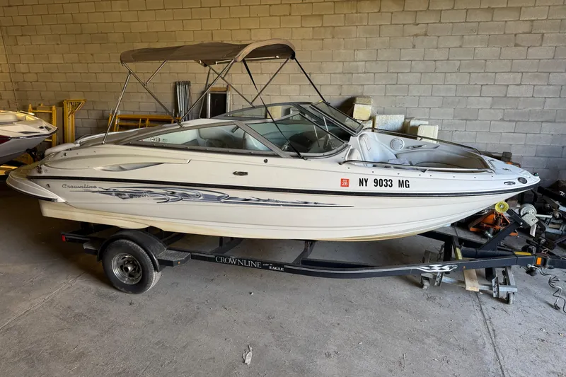 The Image of 2010 Crownline 200 LS boat on trailer in storage facility. - 1