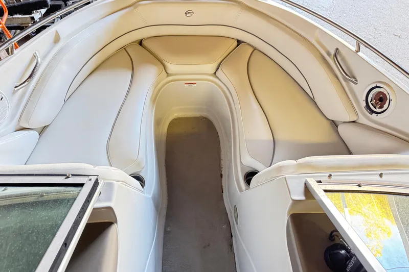 Slide: The Image of 2010 Crownline 200 LS boat interior with white seating and open windshield. - 2