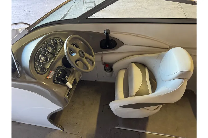 Slide: The Image of 2010 Crownline 200 LS boat interior with steering wheel and dashboard controls. - 4