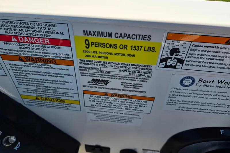 Slide: The Image of 2024 Bayliner VR5 Bowrider OB capacity label, maximum 9 persons or 1537 lbs, safety warnings. - 14