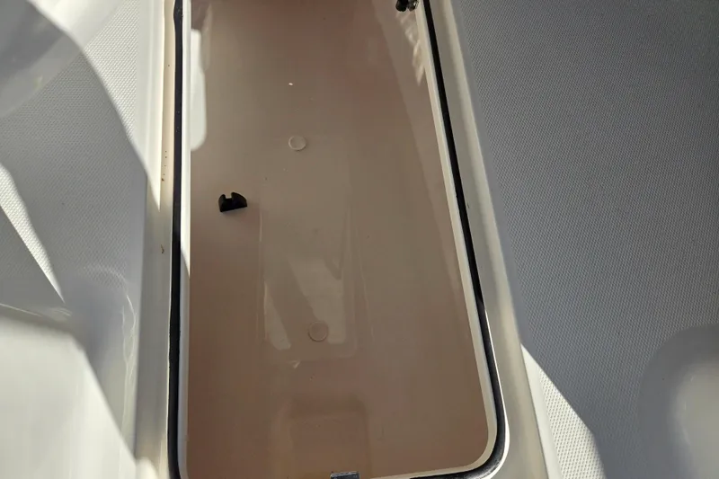Slide: The Image of 2024 Bayliner VR5 Bowrider OB storage compartment, open and empty. - 15