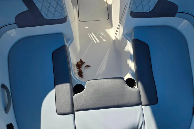 Slide: The Image of 2024 Bayliner VR5 Bowrider OB interior with blue seating and cup holders. - 17