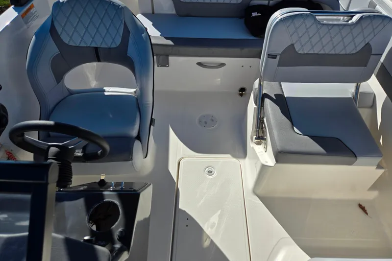 Slide: The Image of 2024 Bayliner VR5 Bowrider OB interior with modern seating and steering wheel. - 19