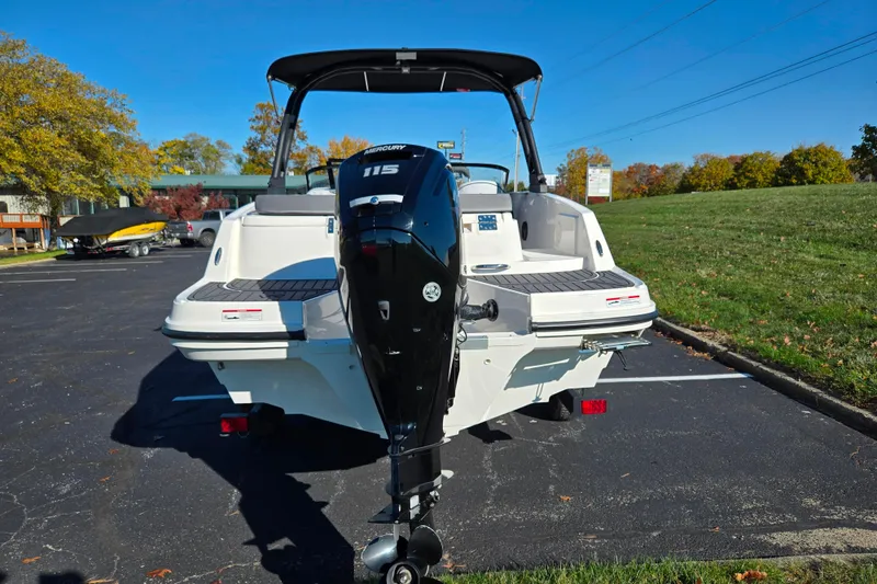 Slide: The Image of 2024 Bayliner VR5 Bowrider OB with Mercury 115 outboard engine, parked outdoors. - 2