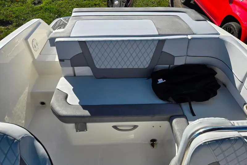 Slide: The Image of 2024 Bayliner VR5 Bowrider OB interior with cushioned seating and storage area. - 20