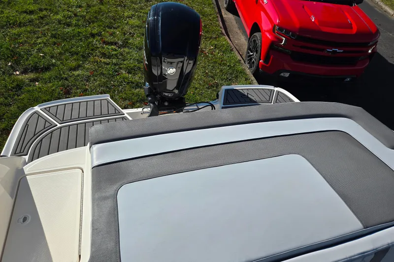 Slide: The Image of 2024 Bayliner VR5 Bowrider OB with outboard motor and red truck nearby. - 21