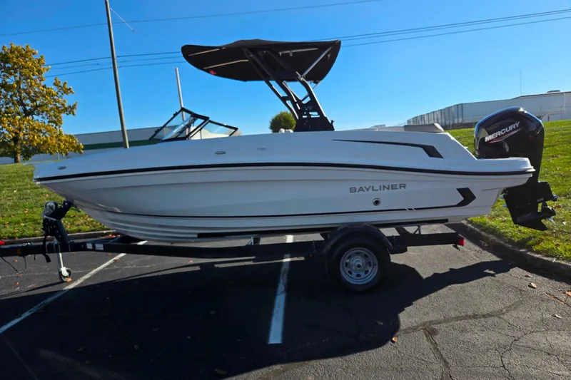Slide: The Image of 2024 Bayliner VR5 Bowrider OB on trailer, parked outdoors, side view. - 4