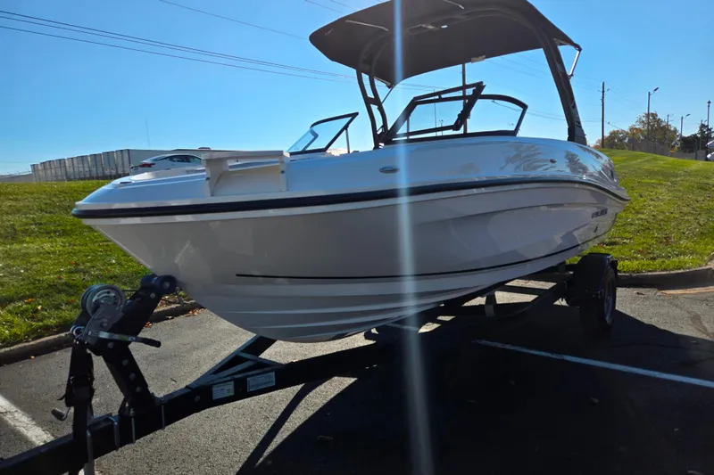 Slide: The Image of 2024 Bayliner VR5 Bowrider OB on trailer, parked outdoors under clear sky. - 5