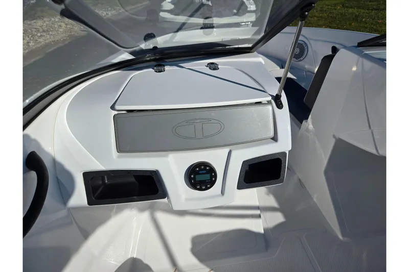 Slide: The Image of 2023 Tahoe 185 S boat dashboard with storage compartments and control panel. - 12