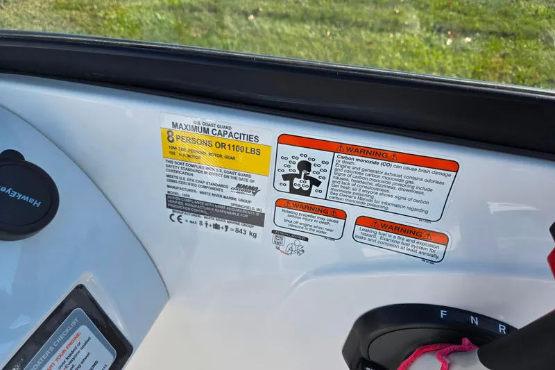 Slide: The Image of 2023 Tahoe 185 S boat capacity and safety warning labels, maximum 8 persons or 1100 lbs. - 14