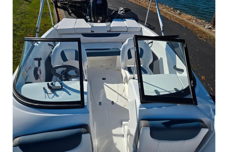 Slide: The Image of 2023 Tahoe 185 S boat interior with open windshield and seating. - 19