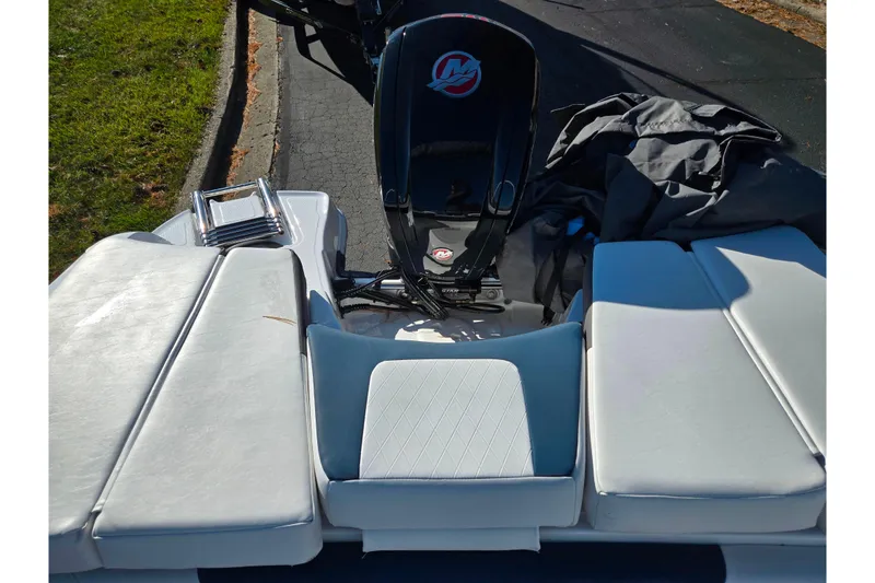Slide: The Image of 2023 Tahoe 185 S boat with cushioned seating and outboard motor. - 22