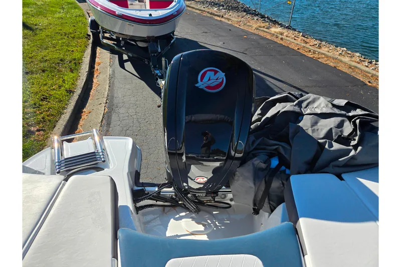Slide: The Image of 2023 Tahoe 185 S boat with outboard motor near a lake. - 23