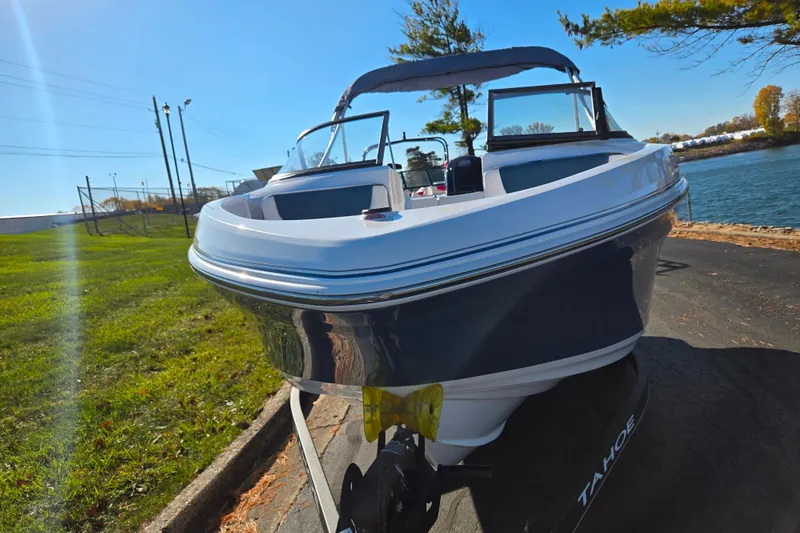 Slide: The Image of 2023 Tahoe 185 S boat on trailer by a lakeside, sunny day. - 6