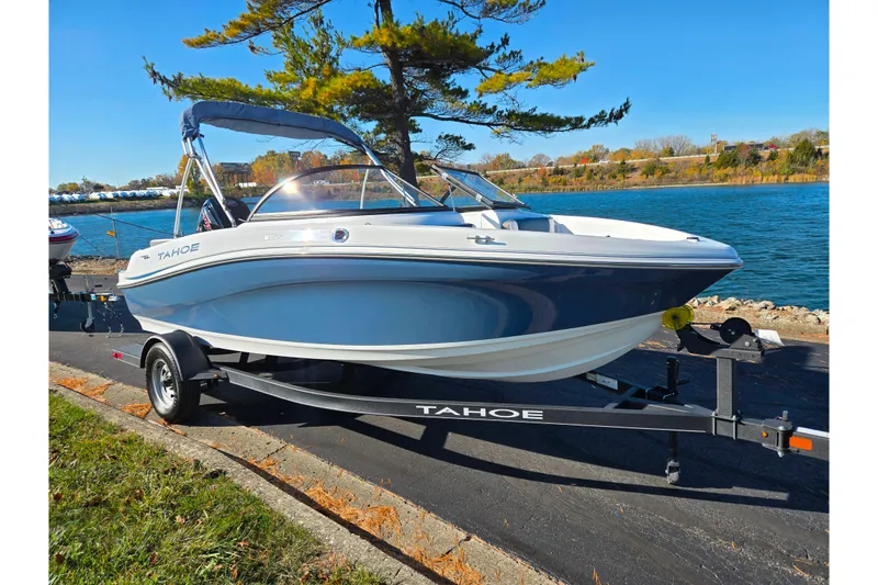 Slide: The Image of 2023 Tahoe 185 S boat on trailer by a scenic lakeside. - 9