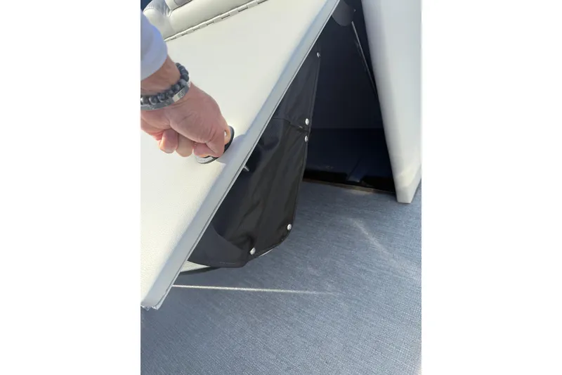 Slide: The Image of Hand opening storage compartment on 2020 SunChaser Geneva Sport 22 LR DH boat. - 6