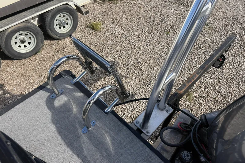 Slide: The Image of 2020 SunChaser Geneva Sport 22 LR DH boat ladder and railing on gravel surface. - 7