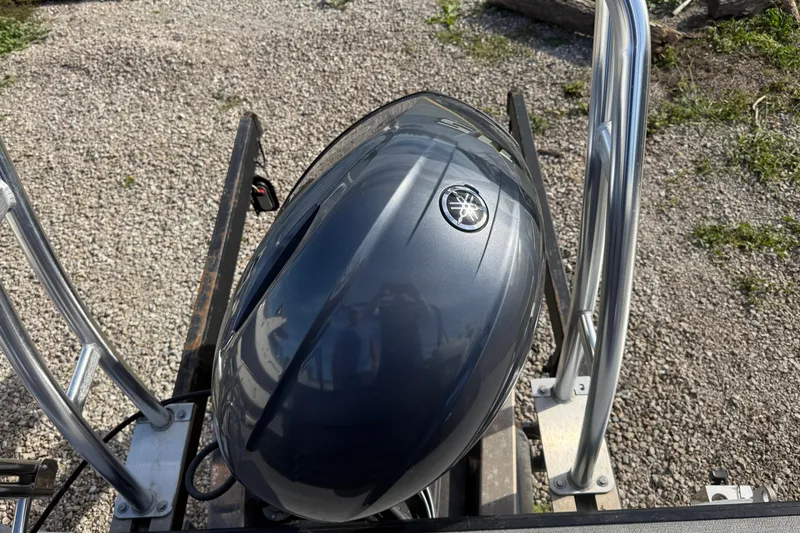 Slide: The Image of 2020 SunChaser Geneva Sport 22 LR DH with Yamaha outboard motor on gravel. - 8