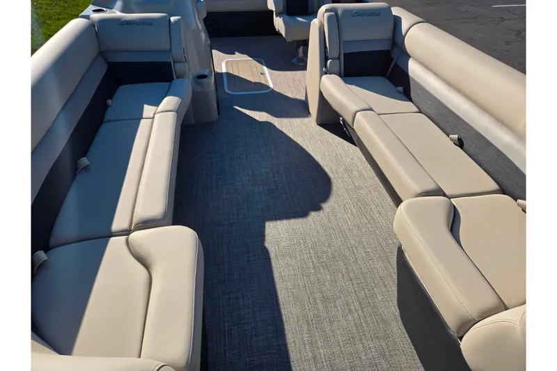 Slide: The Image of 2021 Barletta C24UC pontoon boat interior with beige seating and carpeted floor. - 10