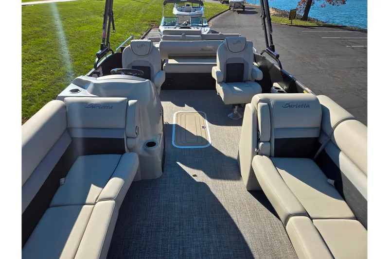 Slide: The Image of 2021 Barletta C24UC pontoon boat interior with plush seating and lake view. - 11