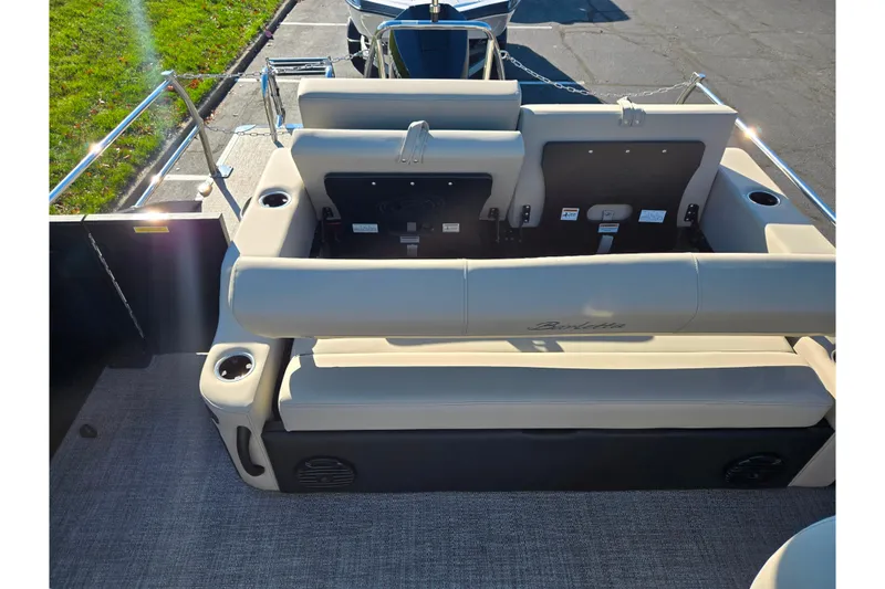 Slide: The Image of 2021 Barletta C24UC pontoon boat interior with beige seating and cup holders. - 13