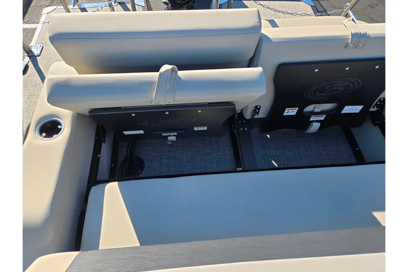 Slide: The Image of 2021 Barletta C24UC boat interior seating with cup holder and storage compartments. - 14