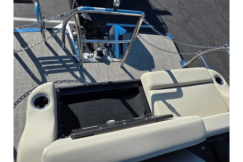 Slide: The Image of 2021 Barletta C24UC boat interior with beige seating and motor controls. - 15