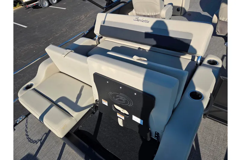 Slide: The Image of 2021 Barletta C24UC boat interior with beige seating and cup holders. - 17
