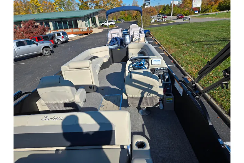 Slide: The Image of 2021 Barletta C24UC pontoon boat interior with steering wheel and seating. - 18