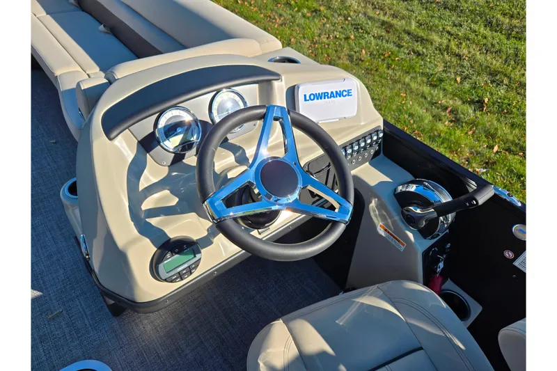 Slide: The Image of 2021 Barletta C24UC boat dashboard with steering wheel and Lowrance display. - 22