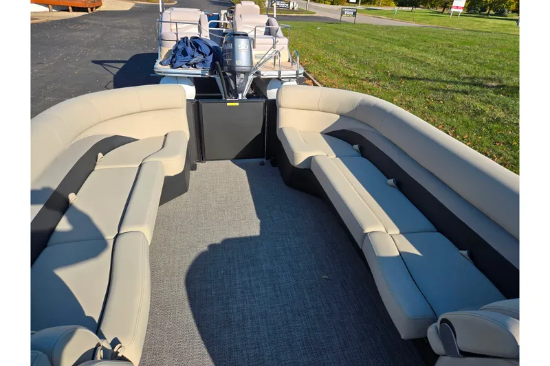 Slide: The Image of 2021 Barletta C24UC pontoon boat interior with beige seating and Yamaha engine. - 23