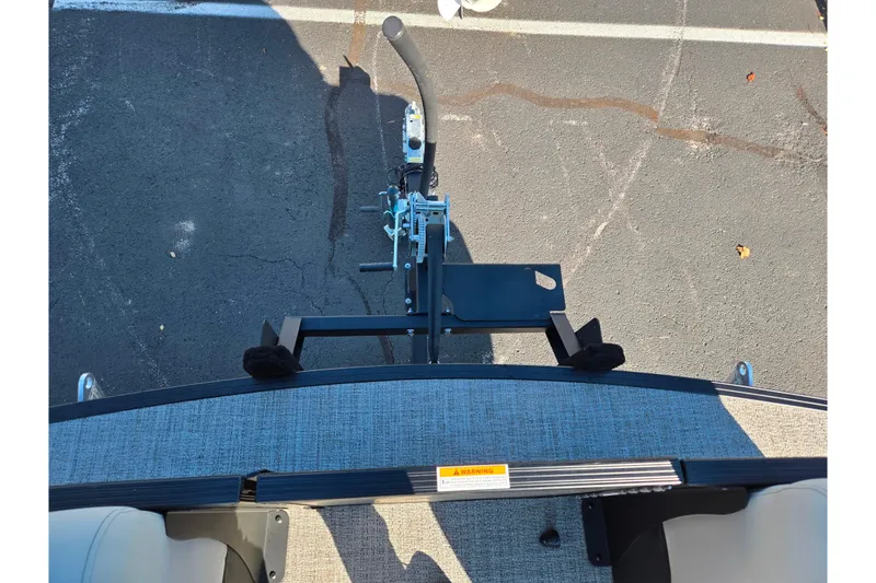Slide: The Image of Top view of a 2021 Barletta C24UC boat trailer hitch on asphalt. - 24