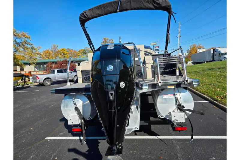 Slide: The Image of 2021 Barletta C24UC pontoon boat with powerful outboard motor in parking lot. - 3