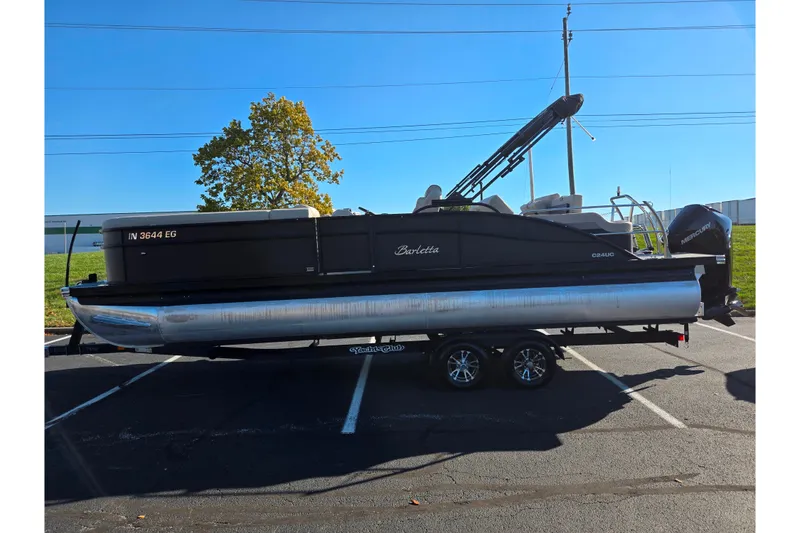 Slide: The Image of 2021 Barletta C24UC pontoon boat on trailer in parking lot, sunny day. - 5