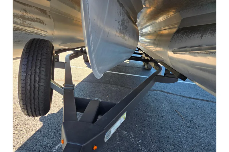 Slide: The Image of Underneath view of a 2021 Barletta C24UC pontoon boat on a trailer. - 8