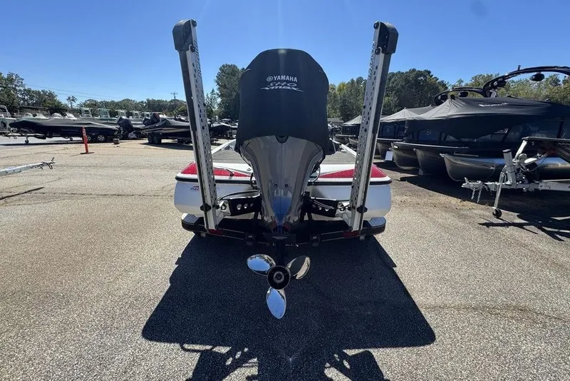 Slide: The Image of 2015 Skeeter ZX225 boat with Yamaha engine, parked in a marina under clear blue sky. - 6
