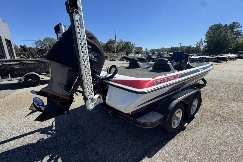 Slide: The Image of 2015 Skeeter ZX225 boat on trailer, featuring Yamaha engine, parked outdoors. - 7